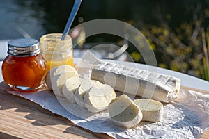 Belgian abbey cheese fagotin in pieces with jam served outdoor, Wallonia, Belgium