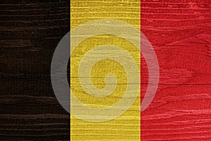 The Belgian flag with the texture of wood. Flag of Belgium on a wooden texture