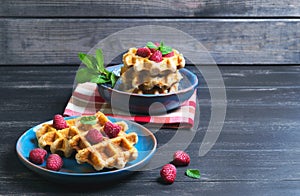 Belgian lush round waffles with fresh raspberries photo