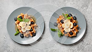 Belgian waffle with honey, banana, nuts and blueberries