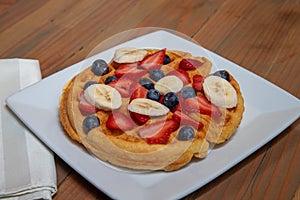 Belgian Waffle served with sliced fruit toppings