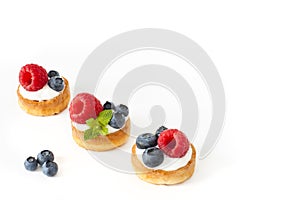 Belgian waffles with blueberry, raspberries and fresh mint on white background