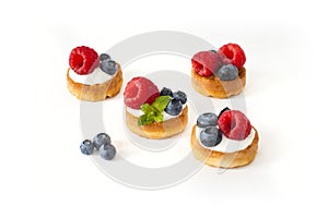 Belgian waffles with blueberry, raspberries and fresh mint on white background