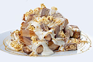 Belgian waffles with caramel topping, chocolate bars and popcorn