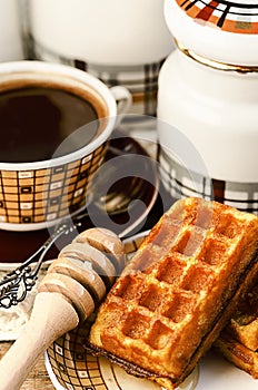 Belgian waffles with coffee and honey on the vintage wooden table