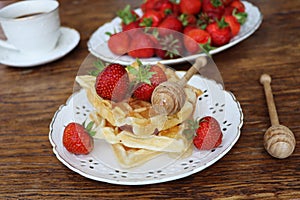 Belgian waffles with fresh berries strawberry , honey and cappuccino coffee for breakfast