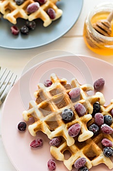 Belgian waffles with honey and frozen berries