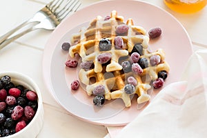 Belgian waffles with honey and frozen berries