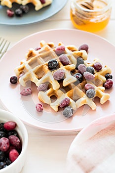 Belgian waffles with honey and frozen berries