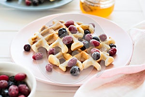 Belgian waffles with honey and frozen berries