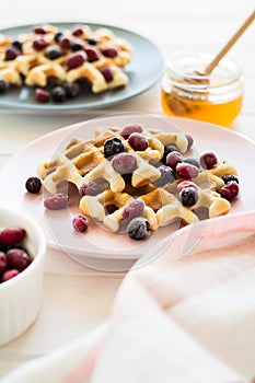 Belgian waffles with honey and frozen berries