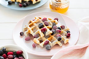 Belgian waffles with honey and frozen berries