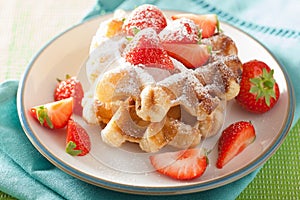 Belgian waffles with icing sugar and strawberry