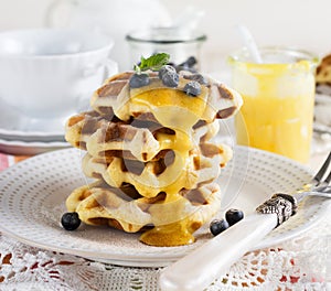 Belgian waffles with lemon Kurd and blueberries. Rustic style. Selective focus
