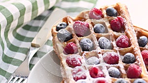 Belgian waffles on plate with berries