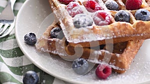 Belgian waffles on plate with berries