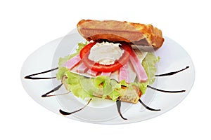 Belgian waffles sandwich with melted cheese and ham.