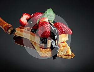 Belgian waffles with strawberries, mint and chocolate sauce