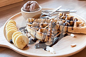 Belgian waffles with strawberry, cherry, blueberry, and chocolate sauce.