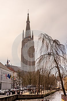 Belgium, Bruges, Brugge, a canal with church of our lady in the background