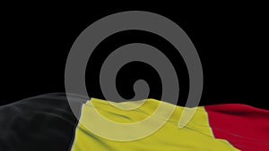 Belgium fabric flag waving on the wind loop. Belgian embroidery stiched cloth banner swaying on the breeze. Half-filled black