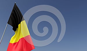 Belgium flag on flagpole on blue background. Place for text. The flag is unfurling in wind. Belgian, Brussels. Europe. 3D