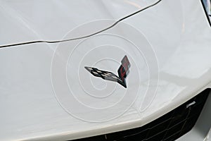 The logo of a white Corvette speed car. Colloquially known as the `Vette