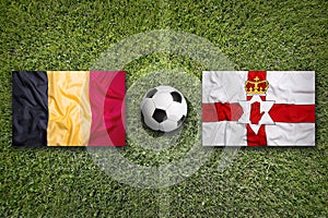 Belgium vs. Northern Ireland flags on soccer field