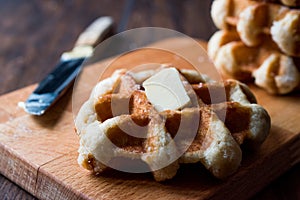 Belgium Waffle with Butter on wooden surface.