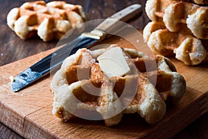 Belgium Waffle with Butter on wooden surface.