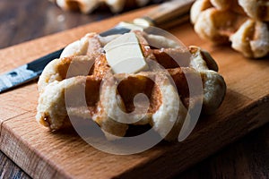 Belgium Waffle with Butter on wooden surface.