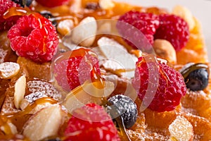 Belgium waffle with fresh berries ,hazelnuts and caramel topping