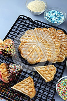 Belgium waffles with chocolate sauce. popsicles with chocolate and wafer on blue background