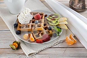 Belgium waffles with ice cream, caramel sauce and fresh berries