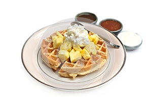 Belgium waffles with pineapple and ice ream on a plate