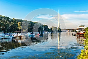 Belgrade, Serbia - 20 June, 2018: Side view of Ada bridge with reflection over Belgrade marina on Sava river