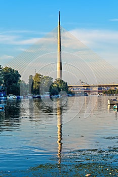 Belgrade, Serbia - 20 June, 2018: Side view of Ada bridge with reflection over Belgrade marina on Sava river
