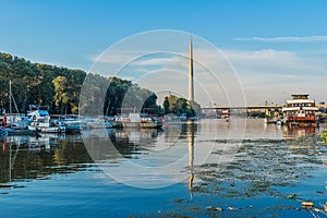 Belgrade, Serbia - 20 June, 2018: Side view of Ada bridge with reflection over Belgrade marina on Sava river