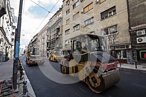 Road roller, small model, on display during a road renovation in belgrade A road roller, or compactor, is used for asphalt