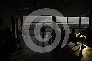 Silhouetts of passengers waiting at airport