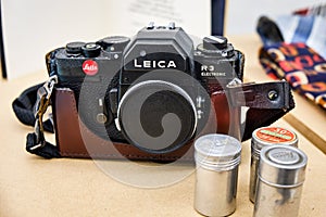 Old Leica R3 35mm SLR camera with packs of film