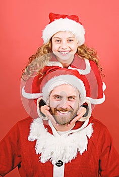 Belief in santa constitutes most magical part of childhood. Girl little cute child and bearded father wear santa costume