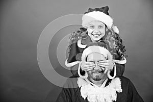 Belief in santa constitutes most magical part of childhood. Guess who. Surprise concept. Girl child and bearded father