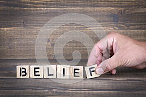 Belief. Wooden letters on the office desk