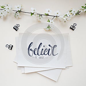 Believe, calligraphic background with spring branch