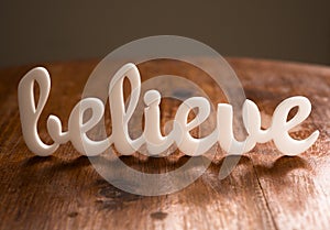 Believe on Wooden Table