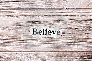 Believe of the word on paper. concept. Words of believe on a wooden background