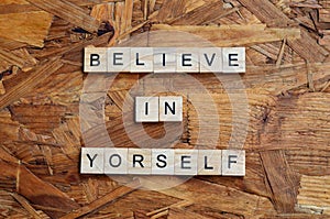 believe in yourself text on wooden square, motivation quotes.