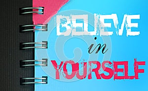 Believe in Yourself words on sky blue page of copybook. Business concept