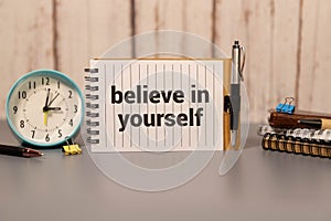 Believe In Yourself, written on an yellow sticky note on a cork bulletin board